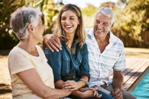 Young woman laughing with aged parents