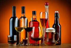 Variety of alcoholic beverages and bottles with an amber background