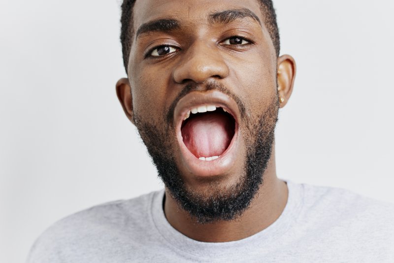 a man opening his mouth to show his tongue