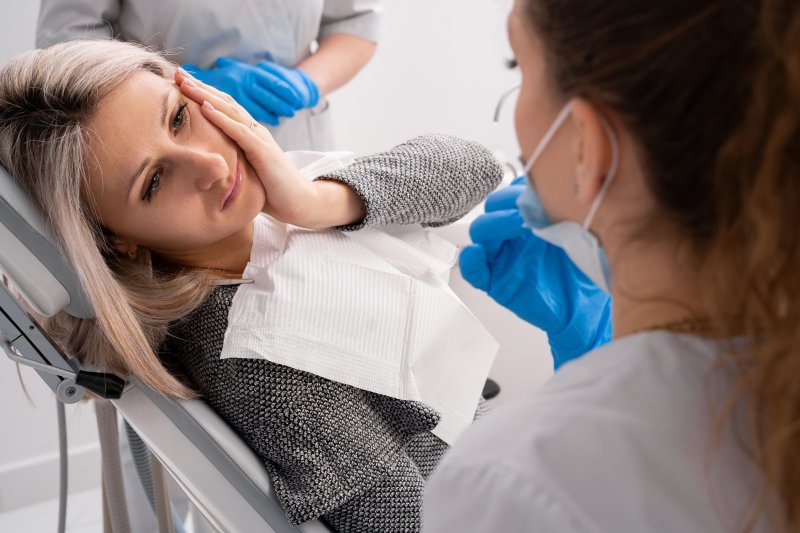 Lady looks unhappy in dentist's chair